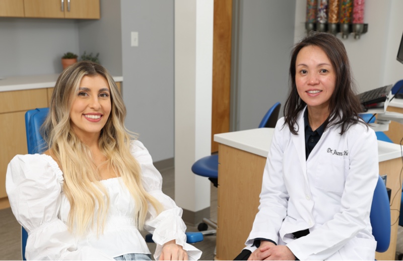 patient smiling with Dr. Yu during visit